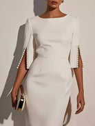 NEWYORKLISTED STYLE COLLECTION: White dress with pearl embellishments on sleeves against a neutral background