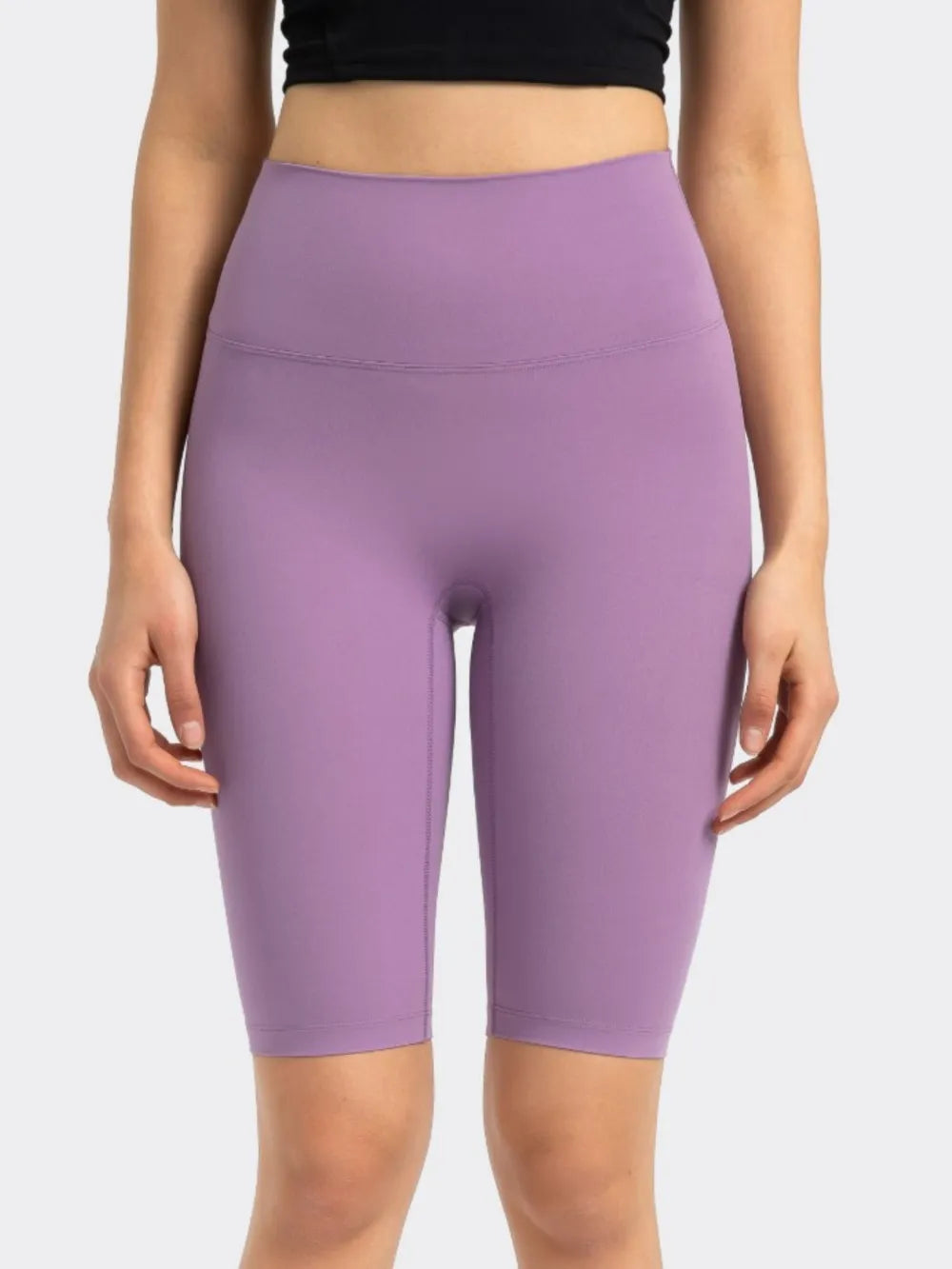 NEWYORKLISTED ACTIVEWEAR COLLECTION: Purple athletic shorts worn by a person on a white background