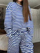 NEWYORKLISTED Comfort Collection: Person wearing a blue and white striped outfit in a room.