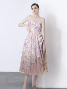 NEWYORKLISTED STYLE COLLECTION: Woman wearing a floral strapless dress against a white background