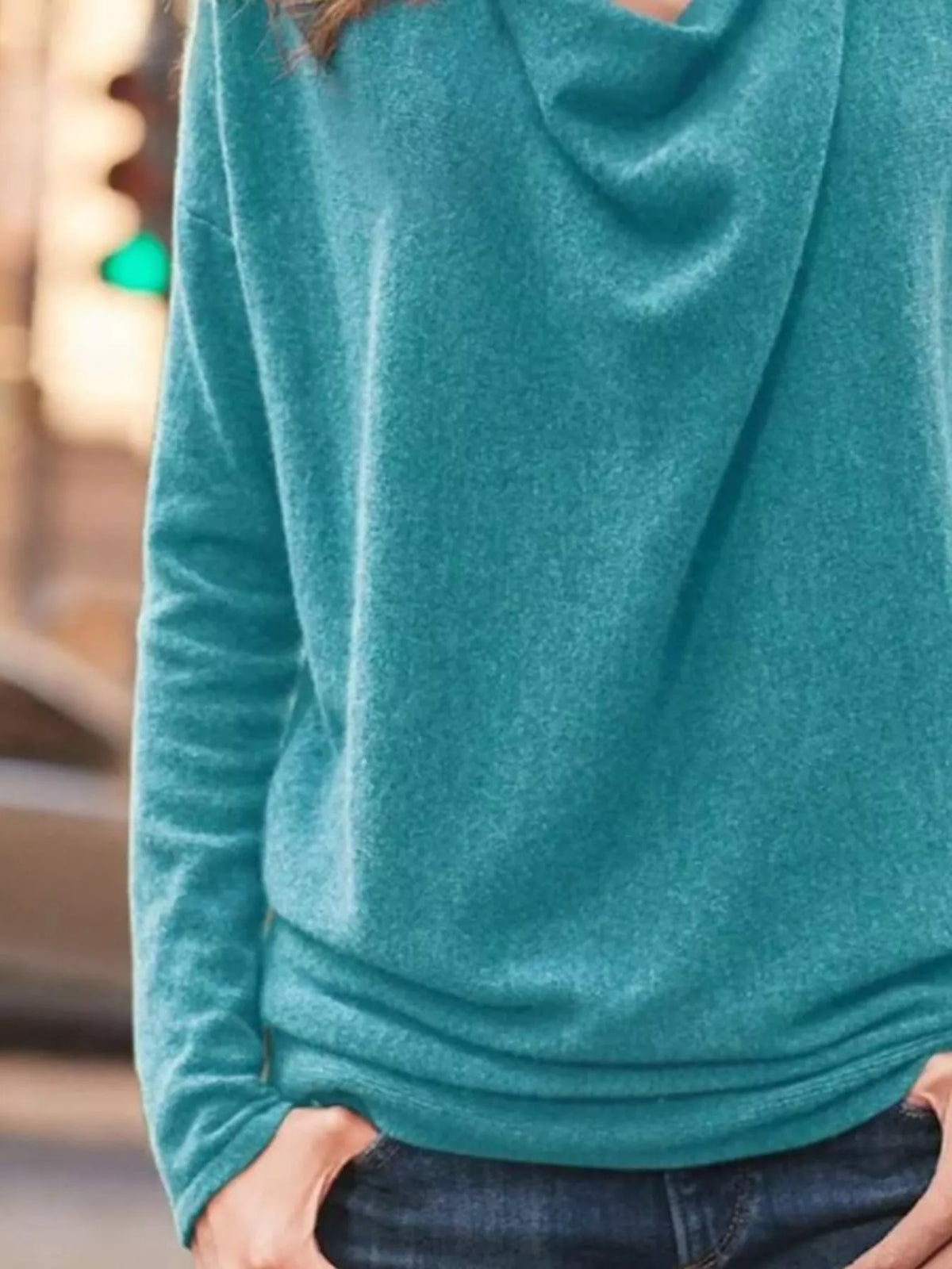 NEWYORKLISTED STYLE COLLECTION: Teal hoodie worn by a person with a blurred background