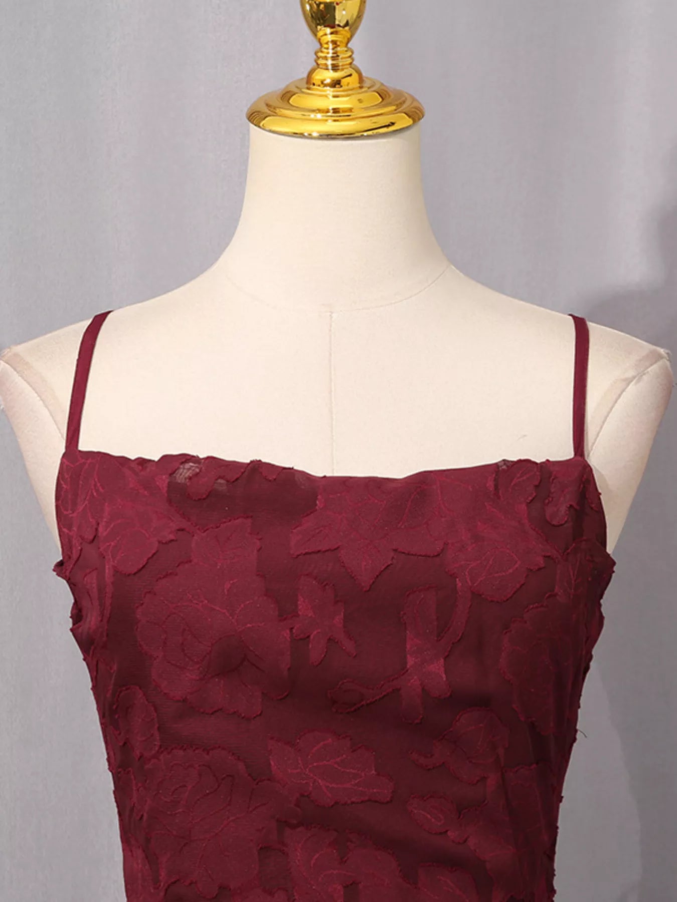 NEWYORKLISTED STYLE COLLECTION: Maroon lace dress on a mannequin with a gray background