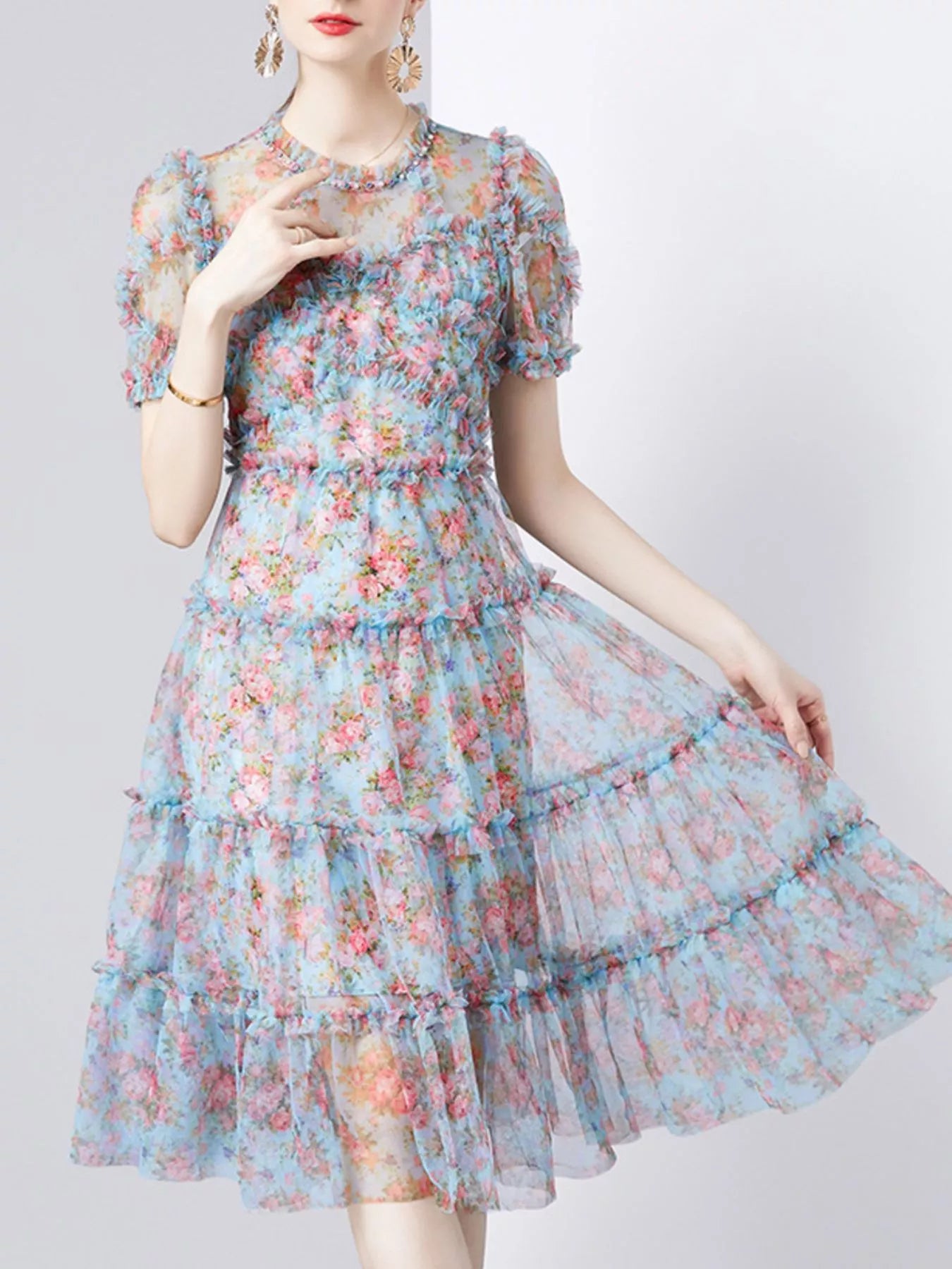NEWYORKLISTED STYLE COLLECTION: Woman wearing a floral dress on a white background