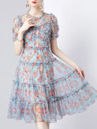 NEWYORKLISTED STYLE COLLECTION: Woman wearing a floral dress on a white background