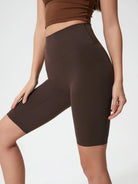 Brown athletic shorts worn by a person on a plain background
