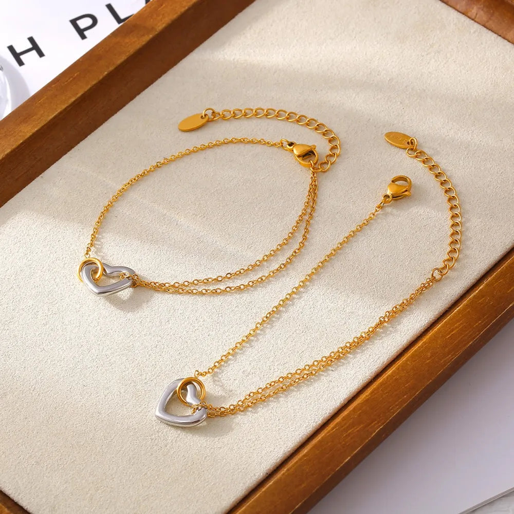 NEWYORKLISTED Valentine's Day Specials: Gold bracelet with heart-shaped charms on a wooden display box.