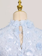 NEWYORKLISTED STYLE COLLECTION: Light blue floral dress on a mannequin with a plain background