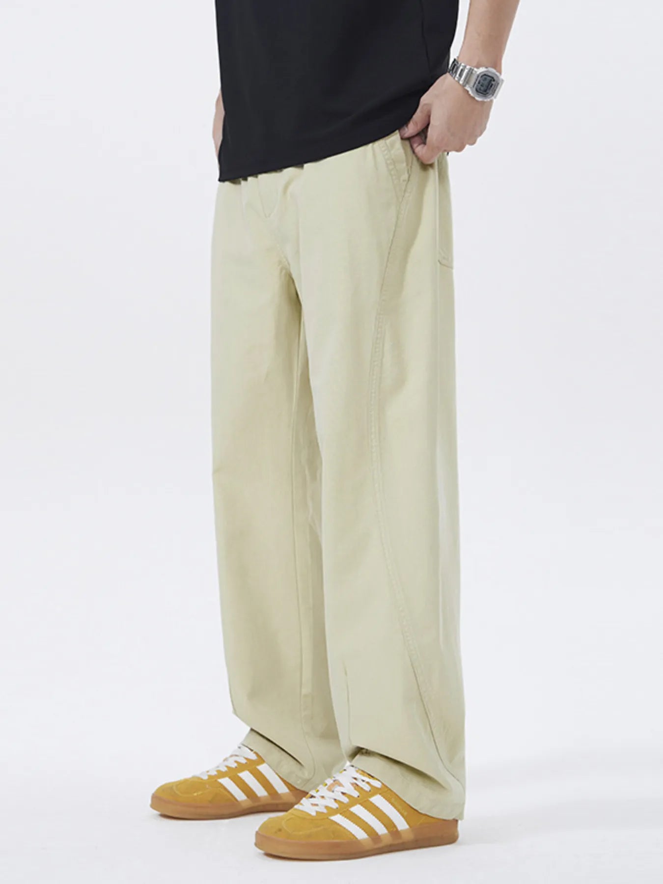 NEWYORKLISTED ATLAS MEN's COLLECTION: Person wearing beige wide-leg pants with a plain background