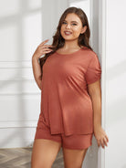 NEWYORKLISTED Intimate Apparel Collection: Woman wearing a rust-colored outfit standing against a white wall.