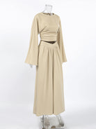 NEWYORKLISTED STYLE COLLECTION: Beige long-sleeve dress on a mannequin against a white background