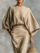 NEWYORKLISTED STYLE COLLECTION: Person wearing a beige outfit with a plain background