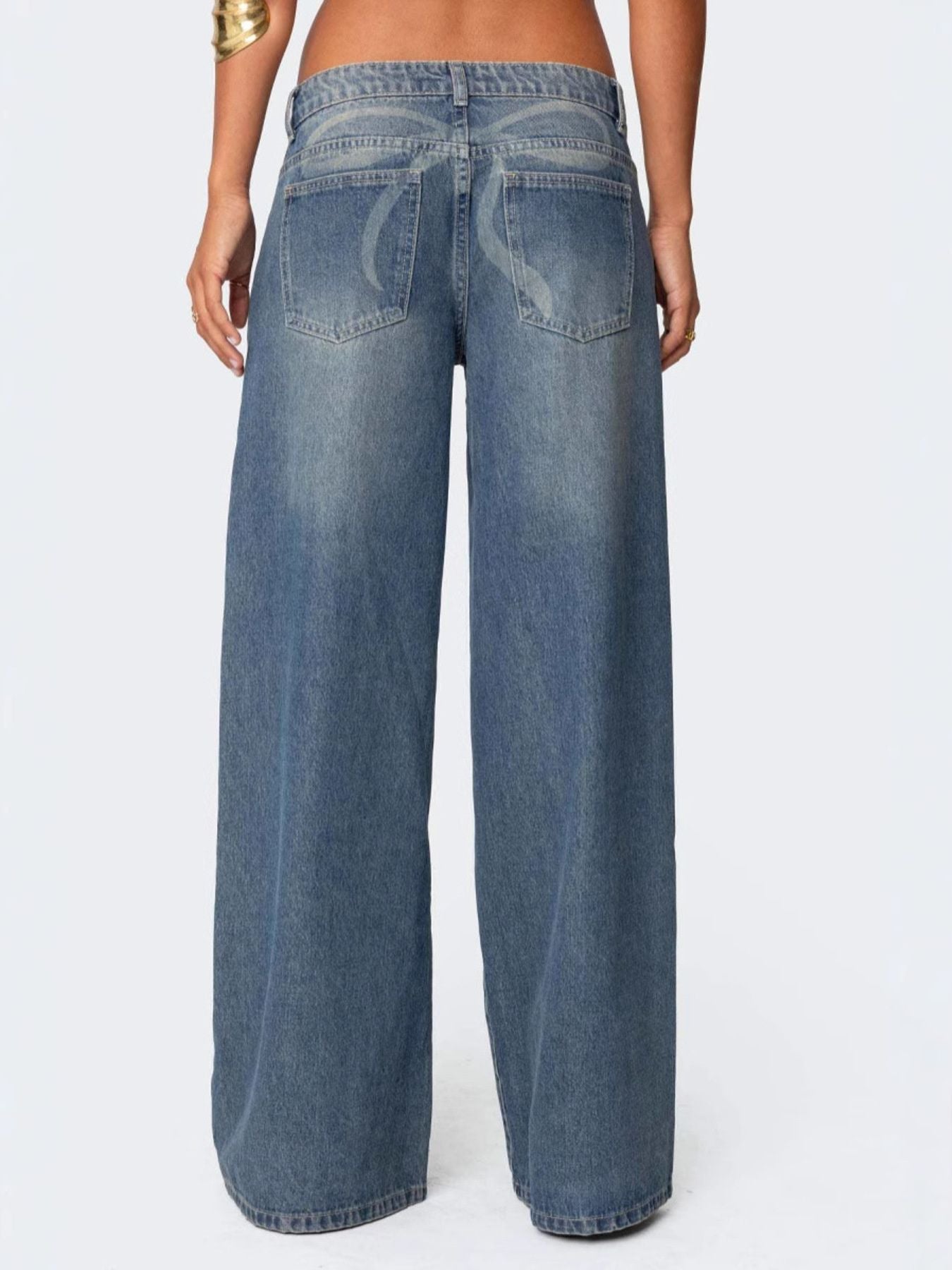 NEWYORKLISTED STYLE COLLECTION: Blue jeans worn by a person on a white background