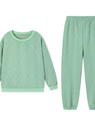 NEWYORKLISTED COMFORT COLLECTION: Green cable knit sweater and pants set on a white background