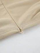NEWYORKLISTED STYLE COLLECTION: Close-up of beige fabric with a zipper on a white background