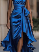 NEWYORKLISTED STYLE COLLECTION: Blue satin dress with a tie waist on a blurred background