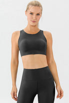 NEWYORKLISTED ACTIVEWEAR COLLECTION: Woman wearing a black athletic outfit on a white background