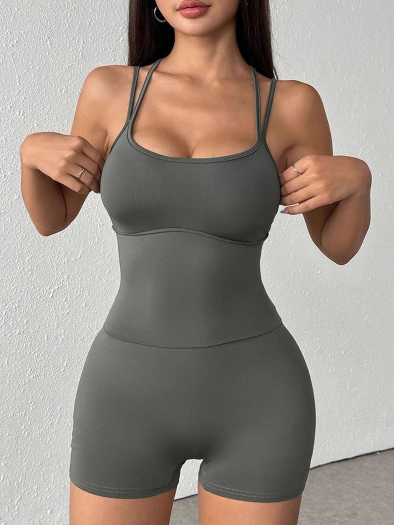 NEWYORKLISTED ACTIVEWEAR COLLECTION: Woman wearing a gray athletic outfit against a white background