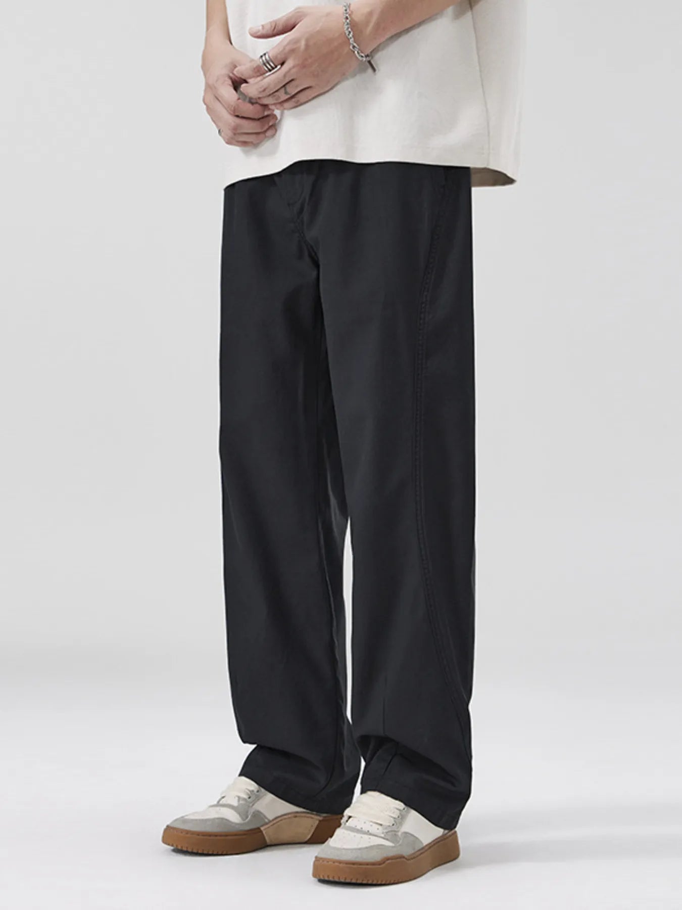 NEWYORKLISTED ATLAS MEN's COLLECTION: Person wearing black pants and a white shirt on a white background