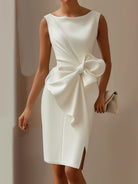 NEWYORKLISTED STYLE COLLECTION: White dress with a large bow detail on a plain background