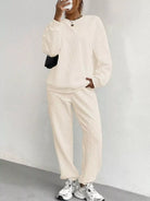 NEWYORKLISTED COMFORT COLLECTION: Person wearing a beige tracksuit against a white background