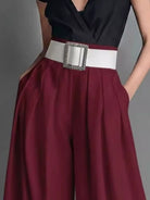 NEWYORKLISTED STYLE COLLECTION: Maroon skirt with a white belt and decorative buckle on a gray background