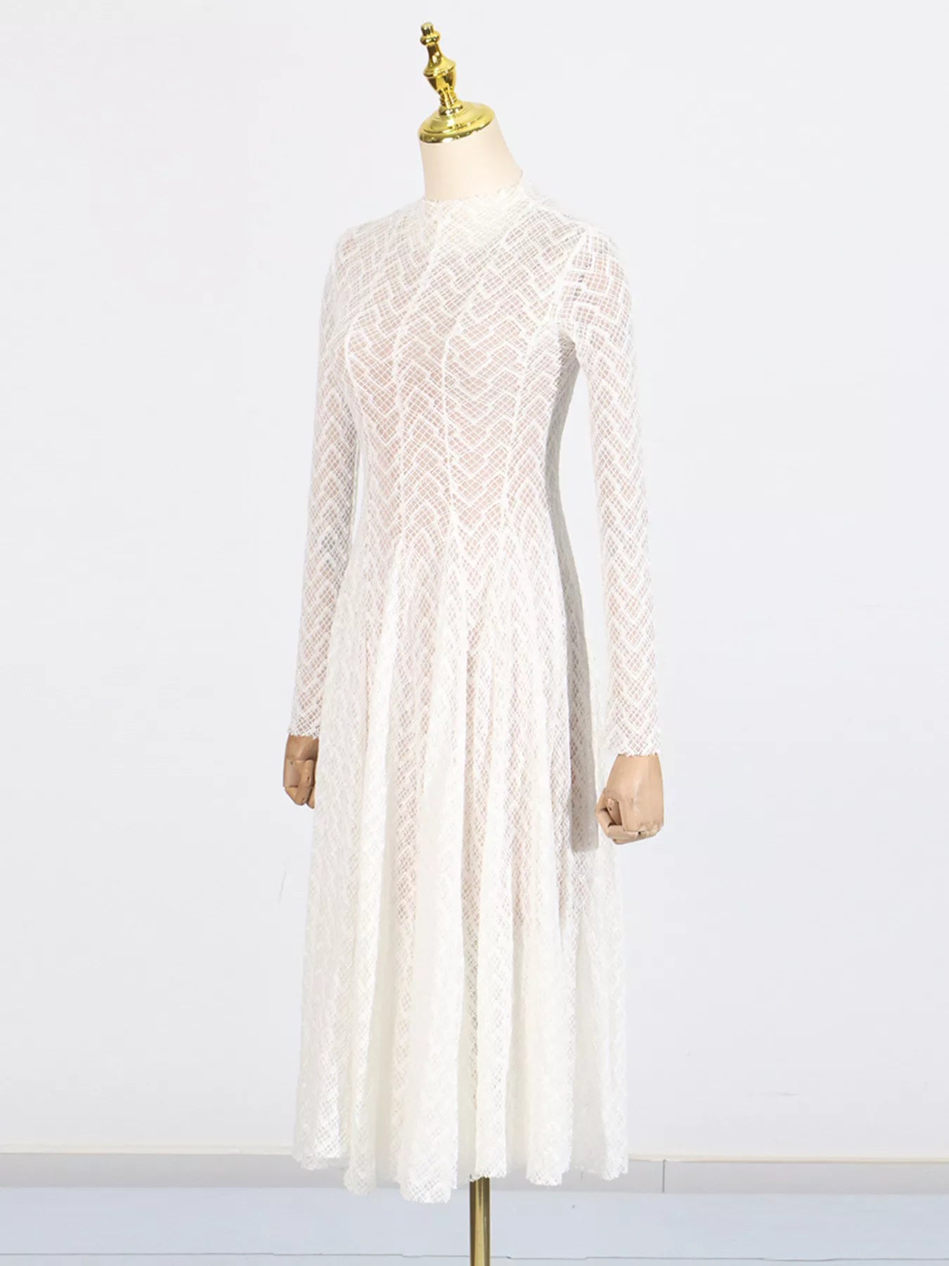 NEWYORKLISTED STYLE COLLECTION: White lace dress on a mannequin against a white background