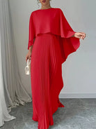 NEWYORKLISTED STYLE COLLECTION: Red pleated dress with cape-like sleeves on a neutral background
