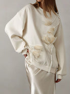 NEWYORKLISTED STYLE COLLECTION: White sweatshirt with floral details on a plain background