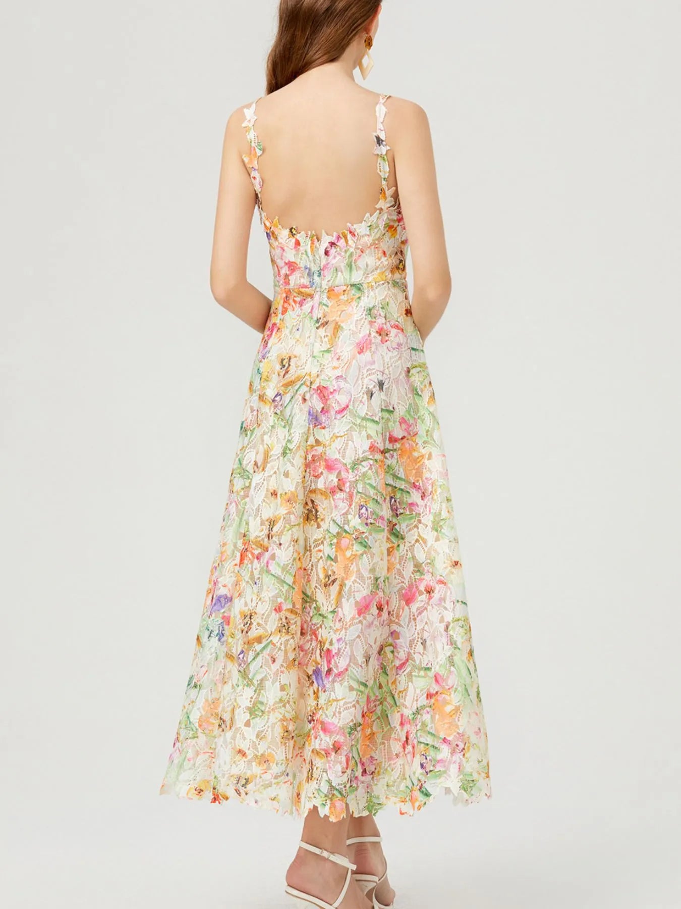 NEWYORKLISTED STYLE COLLECTION: Woman wearing a floral dress on a white background