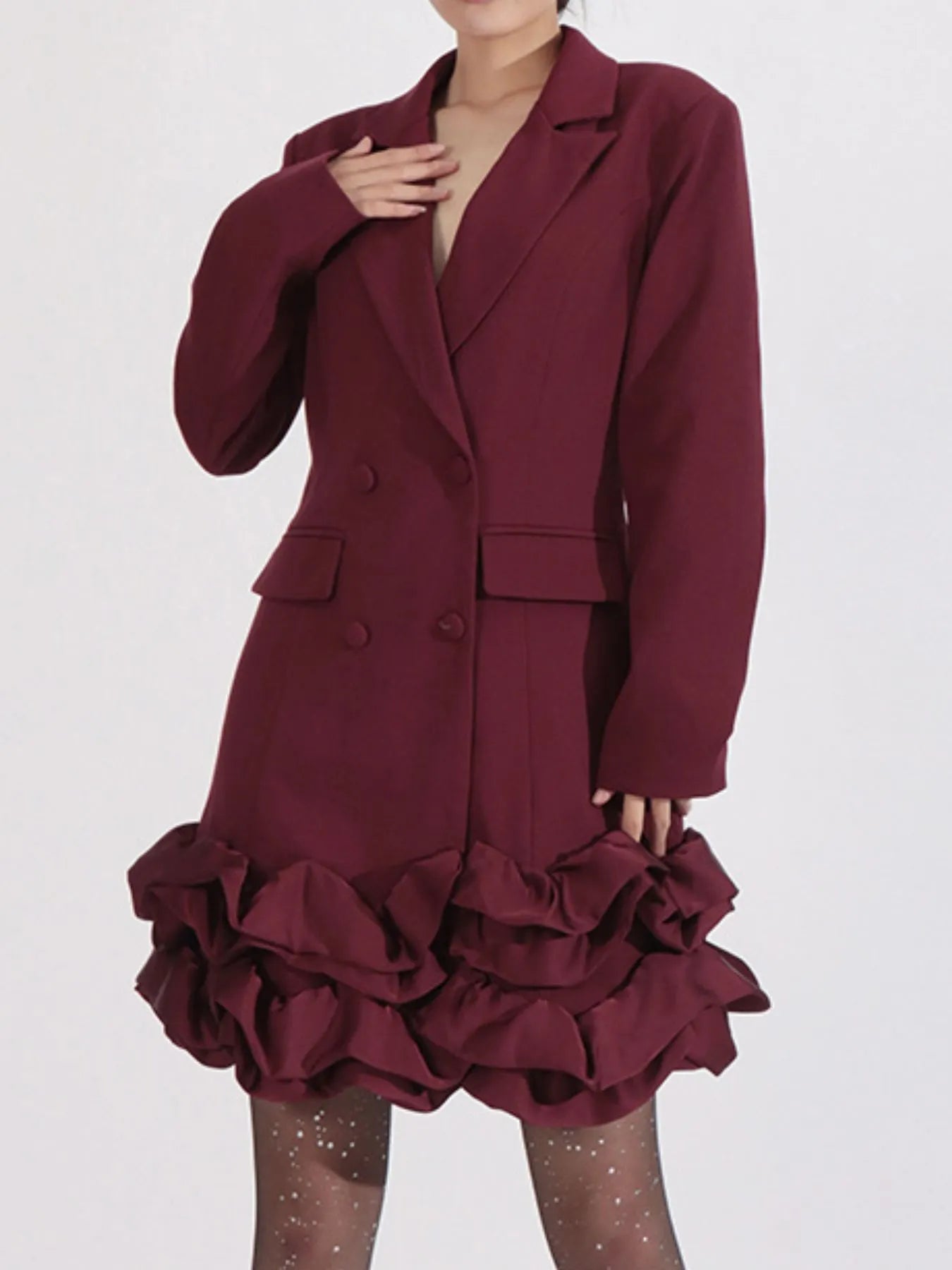 NEWYORKLISTED Runway Style: Maroon coat with ruffled skirt on a white background