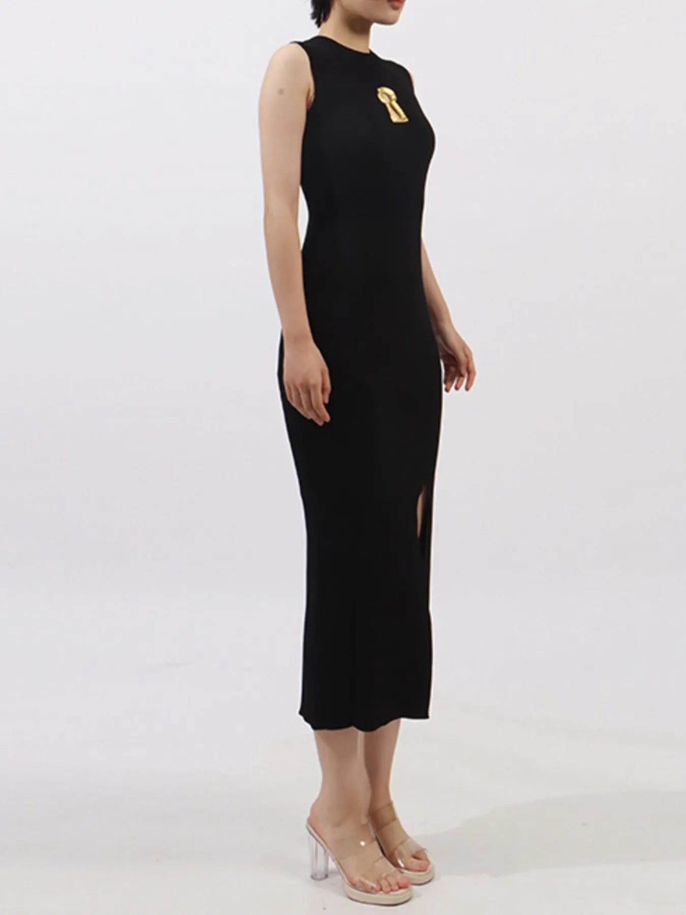 NEWYORKLISTED RUNWAY STYLE: Black sleeveless dress with a gold design on a white background