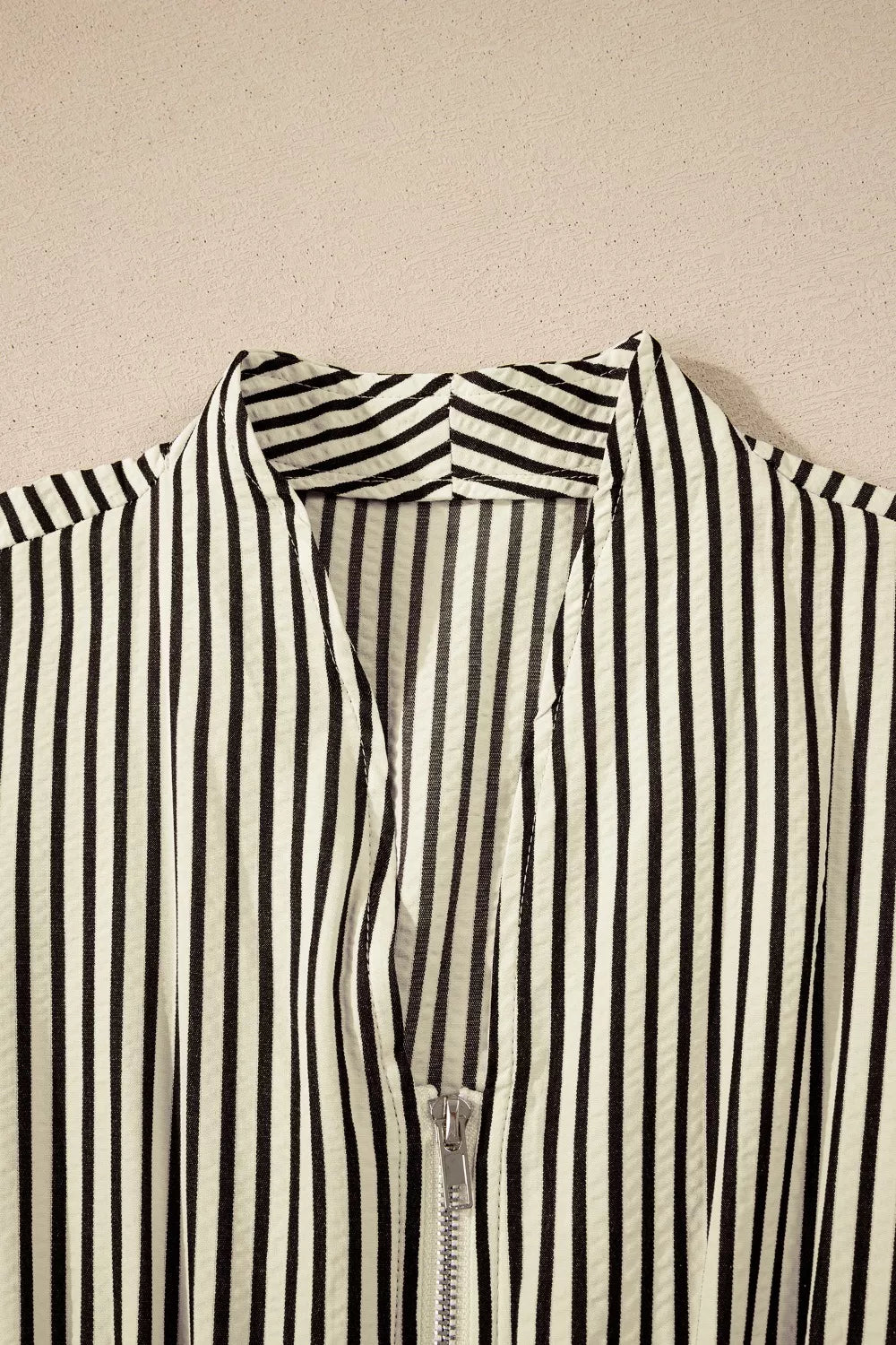 NEWYORKLISTED STYLE COLLECTION: Black and white striped shirt on a beige background