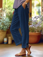 NEWYORKLISTED STYLE COLLECTION: Person wearing blue pants with a blurred indoor background