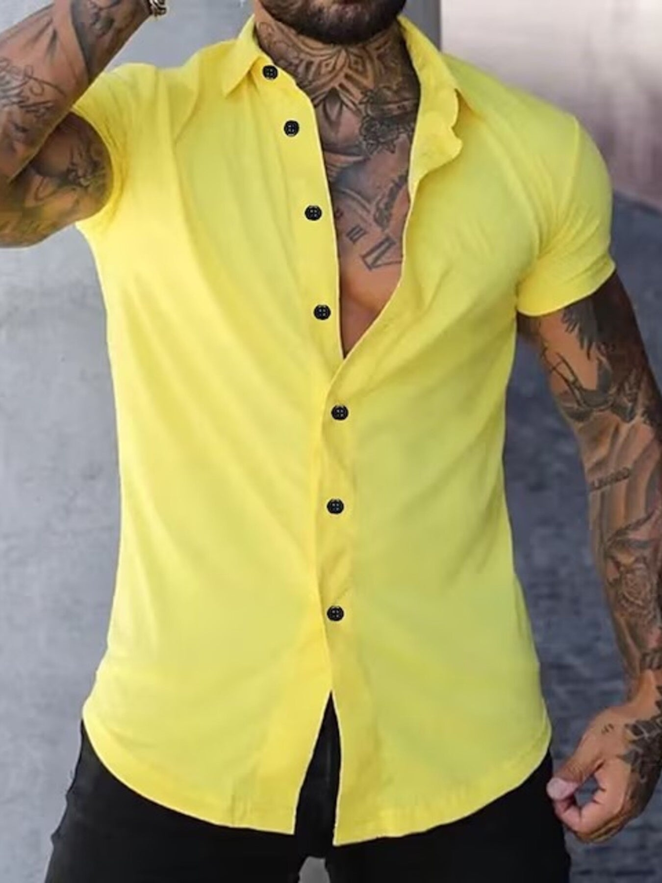 NEWYORKLISTED ATLAS MEN's COLLECTION: Person wearing a yellow button-up shirt with tattoos on arms and neck.