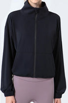 NEWYORKLISTED ACTIVEWEAR COLLECTION: Black jacket worn by a person on a white background