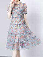 NEWYORKLISTED STYLE COLLECTION: Woman wearing a floral dress on a plain background