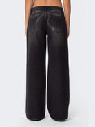 NEWYORKLISTED STYLE COLLECTION: Black wide-leg jeans on a white background