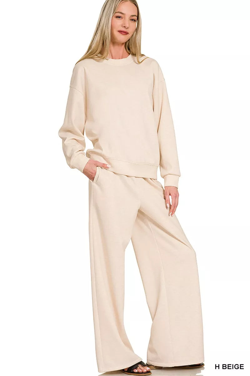 NEWYORKLISTED STYLE COLLECTION: Woman wearing a beige outfit with wide-leg pants on a white background