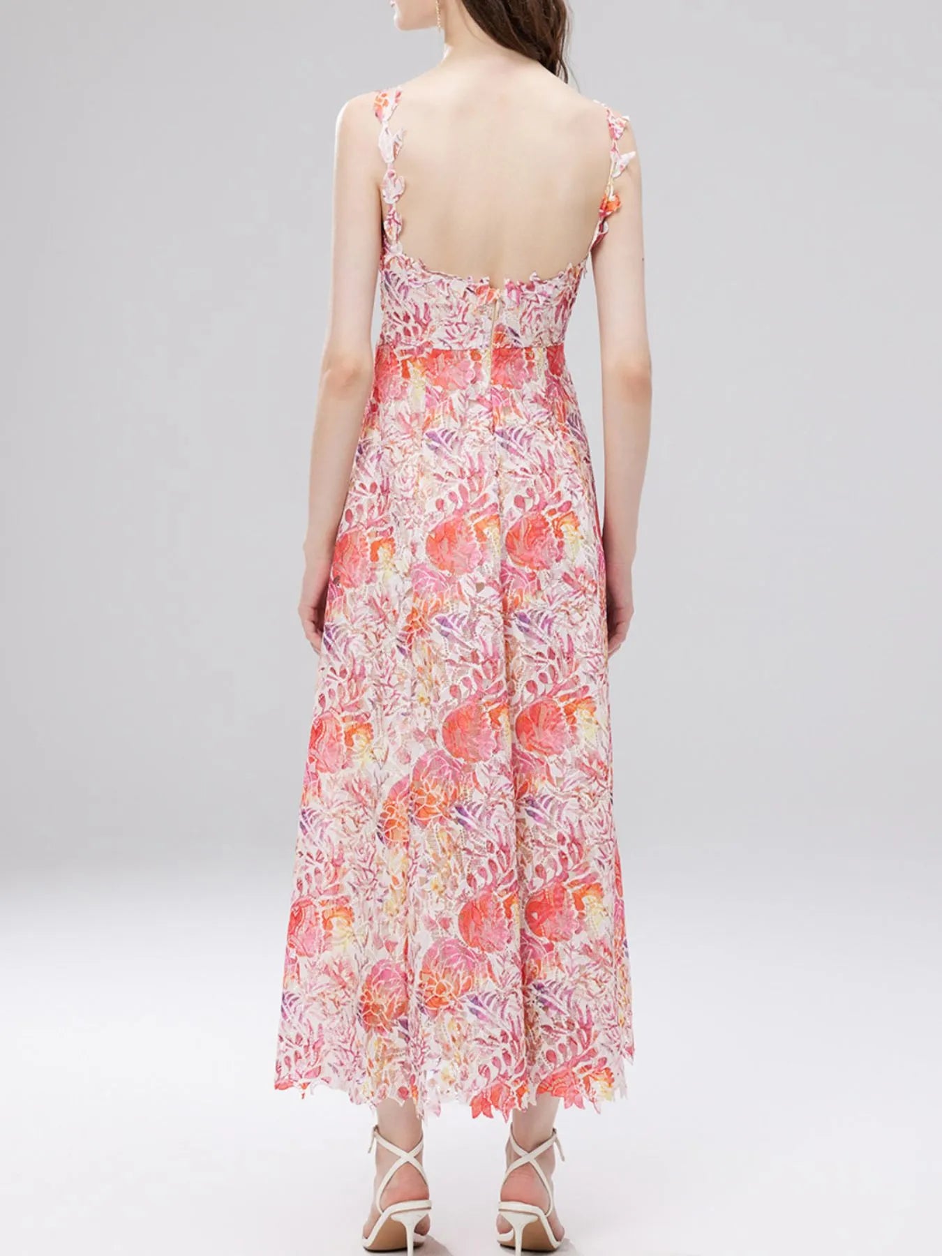 NEWYORKLISTED STYLE COLLECTION: Woman wearing a floral dress on a white background