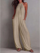 NEWYORKLISTED STYLE COLLECTION: Woman wearing a beige jumpsuit against a plain background