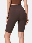 NEWYORKLISTED ACTIVEWEAR COLLECTION: Person wearing brown high-waisted shorts on a plain background