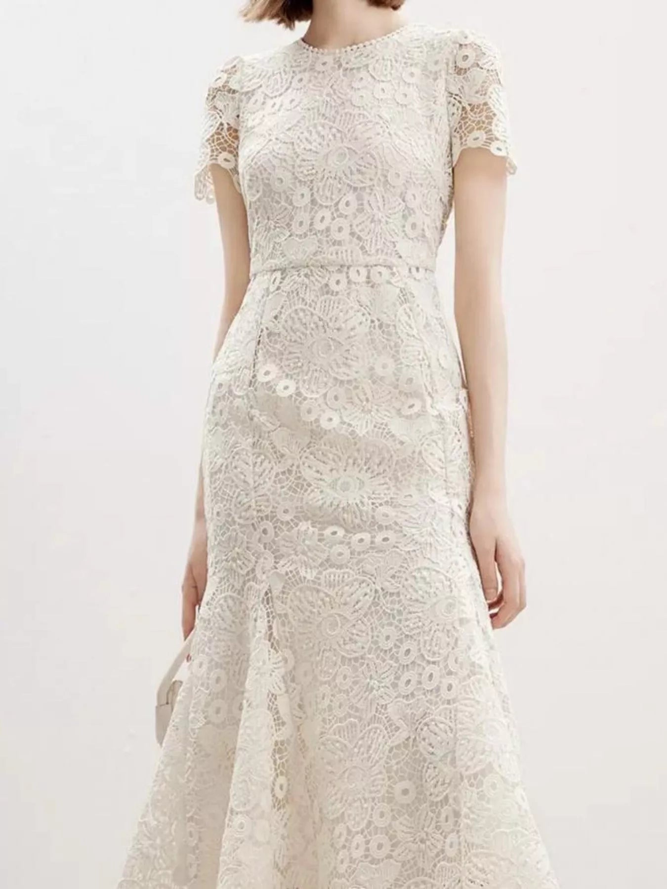 NEWYORKLISTED STYLE COLLECTION: White lace dress on a white background
