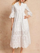NEWYORKLISTED STYLE COLLECTION: White lace dress worn by a model on a beige background