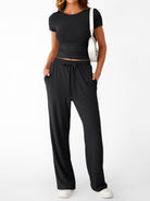 NEWYORKLISTED COMFORT COLLECTION: Woman wearing a black outfit with a white background