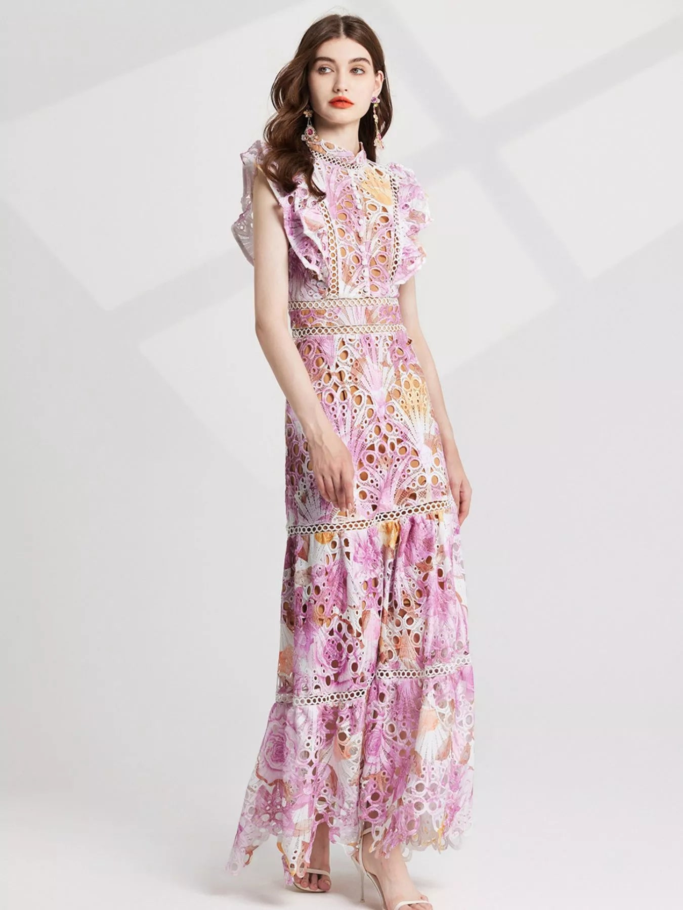 NEWYORKLISTED STYLE COLLECTION: Woman wearing a floral dress on a white background