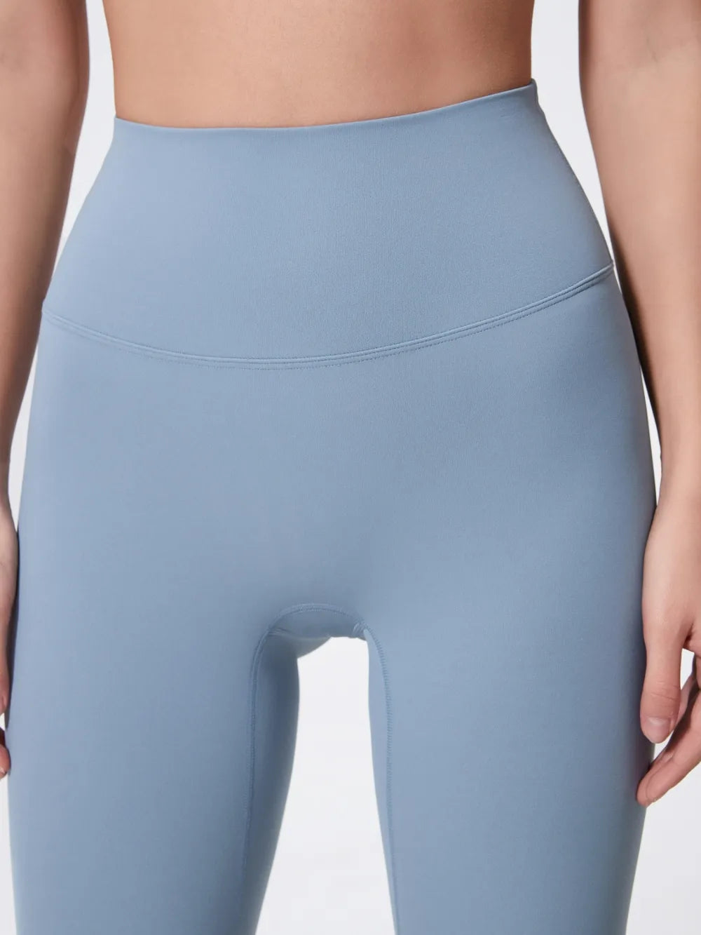 Light blue leggings worn by a person on a plain background