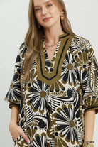 NEWYORKLISTED STYLE COLLECTION: Woman wearing a patterned dress with a neutral background