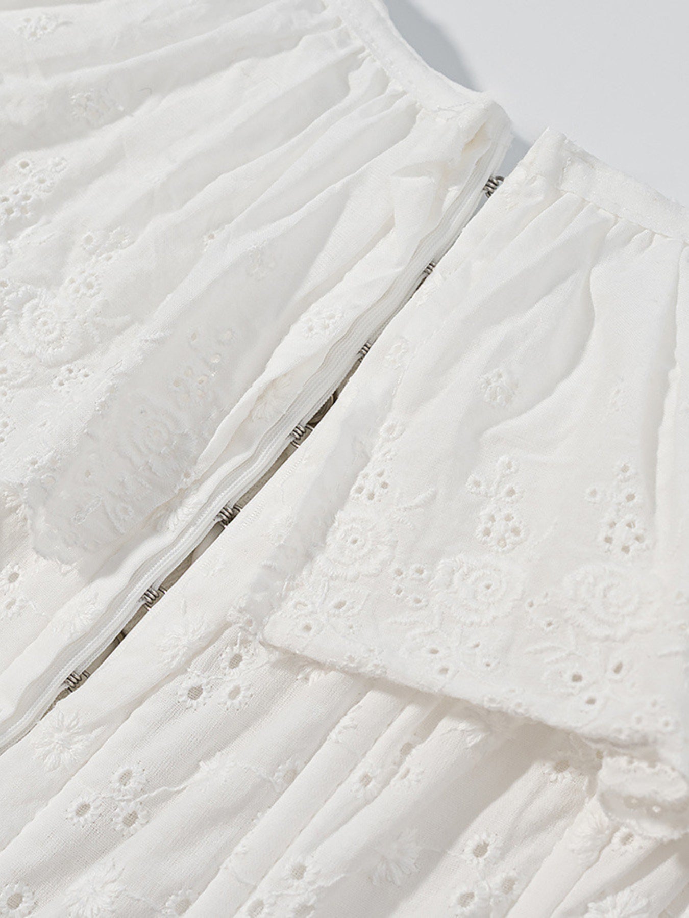 NEWYORKLISTED STYLE COLLECTION: Close-up of a textured white fabric with a subtle pattern